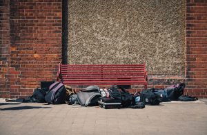 Image of schoolbags left by a bench in a school playground