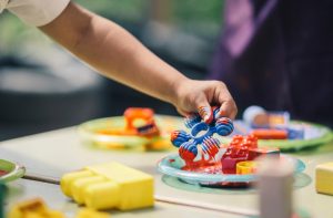 Image of children using paints to make an painting